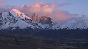 Framed Print : Dramatic sunset over snowy mountains with pink clouds and evening light