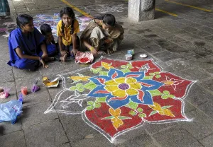 Drawing kolam, rangoli inside the temple floor