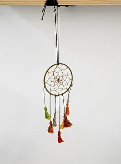 Dreamcatcher hanging in office against wall background