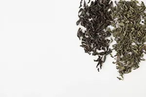 Dried black and green tea leaves on white background