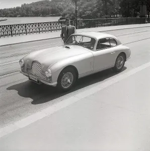 Driving in the 1950s. A man beside his car