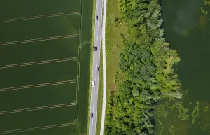 Drone image, country road between fields and pond
