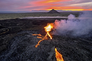 Category Mountain Landscapes Prints: Drone image of a volcanic eruption in the evening light in Grindavik