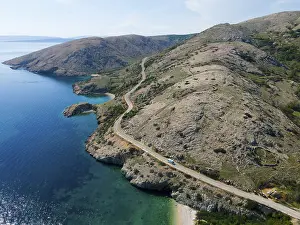 Drone shot, bays and karstic mountains on the rugged coast near Stara Baska