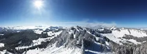 Drone shot, deep snowy winter landscape in the Osterhorn group with view to Pillstein