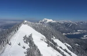 Drone shot, deep snowy winter landscape in the Osterhorn group with view to the Zwoelferhorn and Wolfgangsee