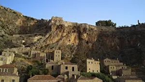 Drone shot, medieval buildings on a rocky cliff overlooking the Mediterranean Sea at sunset