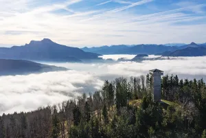 Drone shot, sea of fog in the Mondseeland with observation tower on the Kulmspitze