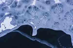 Drone view. Abstract forms created on surface of freezing lake
