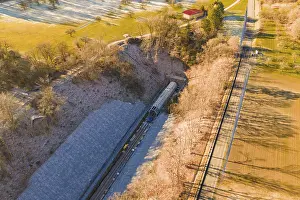 Framed Print : Drone view of a railway line through an autumn landscape with meadows and forests