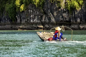 A dugout canoe with a seated person glides silently through clear