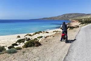 E-bike cycle tour, Bestager enjoys view of turquoise blue water and dream beach