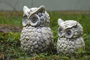 Two eagle owl figures in the garden