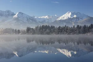Early morning mist on lake Hopfensee in winter