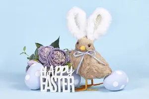 Easter chick with bunny ears, painted eggs and text Happy Easter on blue background