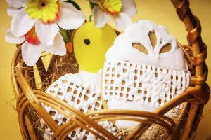 Easter cookies in basket over yellow background
