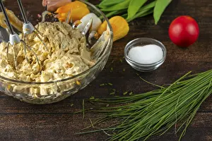 Egg salad in a glass bowl with a mixer