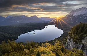 Eibsee lake at sunrise, sun shining over Bavarian alpine foothills