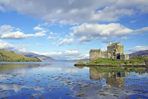Eilean Donan Castle reflected in the water on a calm evening