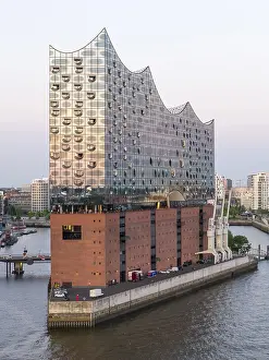 The Elbphilharmonie concert hall in Hamburg is reflected in the glass design above the historic Kaispeicher warehouse