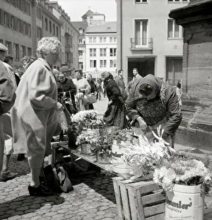 Elderly lady buys a bouquet of flowers