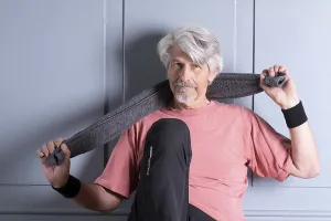 Elderly man with fitness outfit rests after training