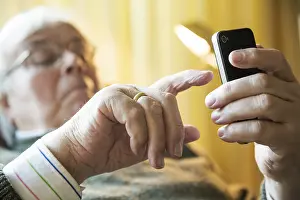 Elderly man working on his smartphone
