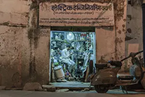 Electronics retailer in his workshop in the evening