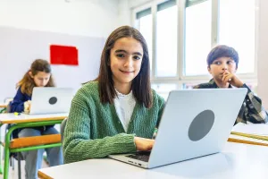 Elementary school student using laptop during class
