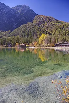 Emerald green, clear shore water with visible stones