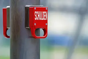 Emergency brake with the german word Schulden for Debts