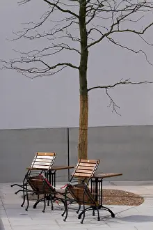 Empty, chained chairs at a garden restaurant