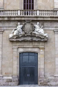 Entrance door with sculptures above on a decorative building in La Rambla street