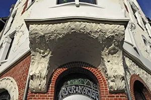 Entrance to a house and underside of a bay window with Art Nouveau elements around 1900