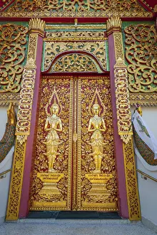 Entrance portal full of golden details to the buddhist temple