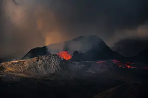 Erupting volcano with lava fountains and lava field