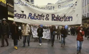 Essen. Students against red pencils and armament with missiles