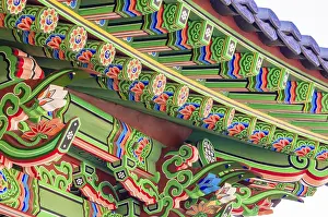 Eve of a Buddhist temple building with vibrant green