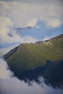 Evening light on the mountauns and clouds hanging in the mountains