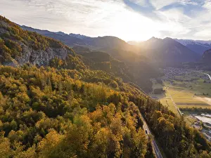 Evening sunset over autumn forest and mountain landscape