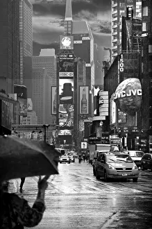 Evening Times Sqaure with illuminated advertising in the rain