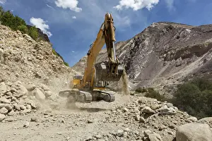 Excavator doing road construction in Himalayas