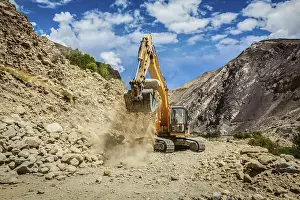 Excavator doing road construction repair in Himalayas
