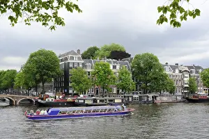 Excursion boat, canal houses on the Amstel River