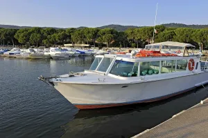 Excursion boat, motorboat and yachts in the marina of Bolsena