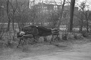Exhausted man sleeping on a bank