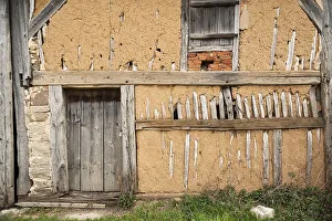 Exposed clay plaster wall of a barn