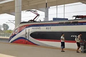 Category Historic EN Prints: Express train of the Laos-China Railway LCR at the platform of the modern railway station of Vientiane