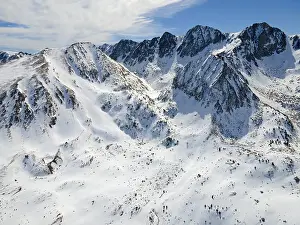 Extensive snow-covered mountain landscape with striking peaks