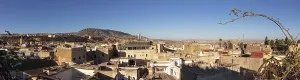 Extensive urban landscape with hills in the background and clear sky